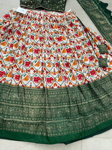 Green Dola silk and patola print Lehengas