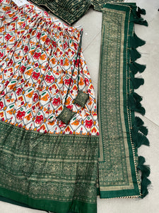 Green Dola silk and patola print Lehengas