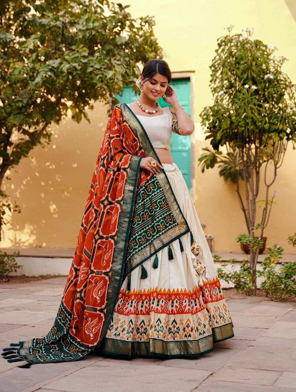 Tussar silk and patola print Lehenga in white and orange