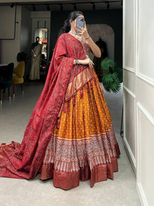 Sangeet nights - dola silk with bandhani and ajrakh print chaniya cholis (skirt stitched) in orange.