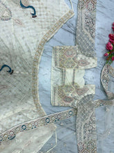 Ivory lehenga with peacock and sequin embroidery