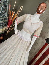 White lehenga with thread work and green bandhani dupatta