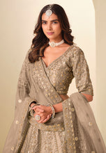 Champagne and gold embroidered art silk Lehenga
