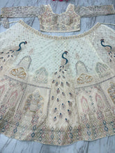 Ivory lehenga with peacock and sequin embroidery
