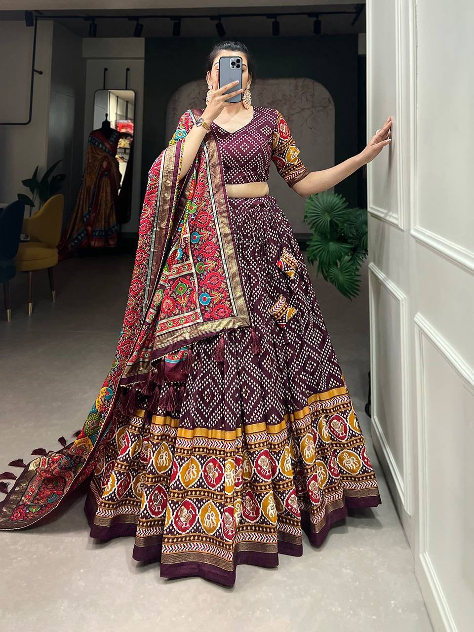 Royal ensemble of bandhej and patola print Lehenga in wine