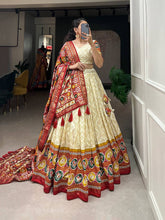 Royal ensemble of bandhej and patola print Lehenga in offwhite