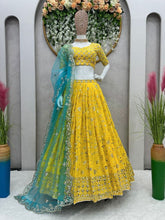Yellow sequins Lehenga paired with blue net dupatta