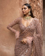 Rose champagne net saree with tassels on blouse