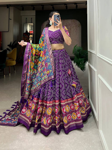 Royal ensemble of bandhej and patola print Lehenga in purple