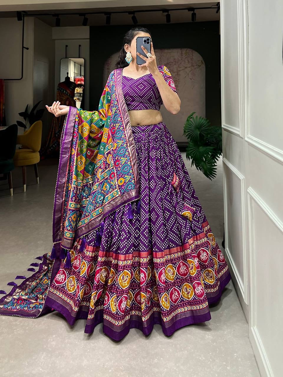 Royal ensemble of bandhej and patola print Lehenga in purple