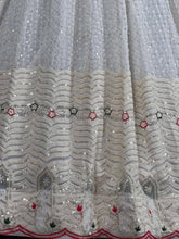 White lehenga with thread work and green bandhani dupatta