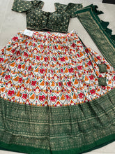 Green Dola silk and patola print Lehengas