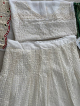 White lehenga with thread work and green bandhani dupatta