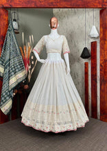 White lehenga with thread work and green bandhani dupatta