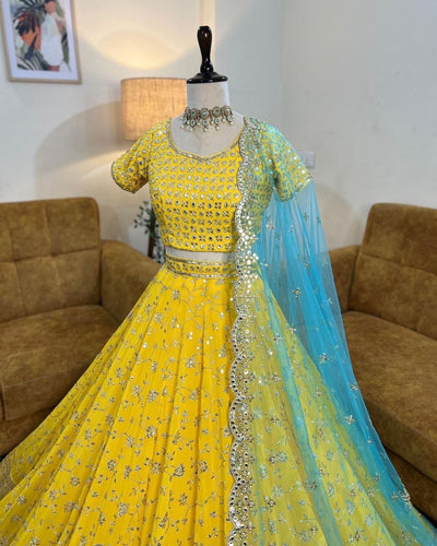 Yellow sequins Lehenga paired with blue net dupatta