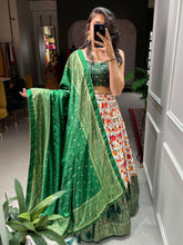 Green Dola silk and patola print Lehengas