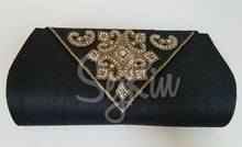 Black triangular flap clutch