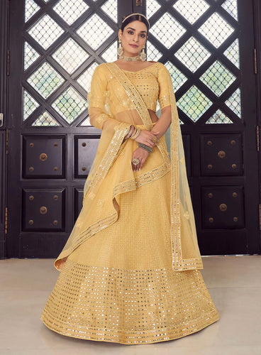 Kavya catalogue: Yellow mirror work Lehenga