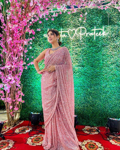 Celebrity inspired peachy pink swirly sequinned saree