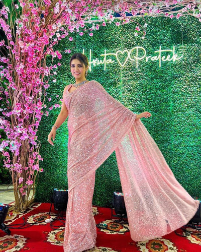 Celebrity inspired peachy pink swirly sequinned saree